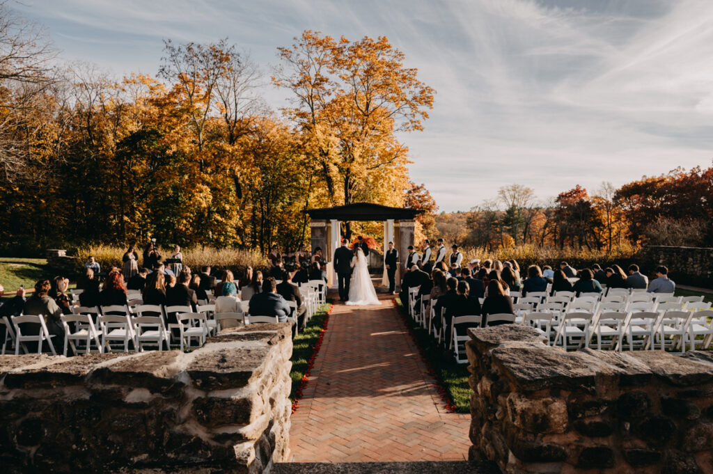 A view of the ceremony from the back Connecticut Fall wedding photography 