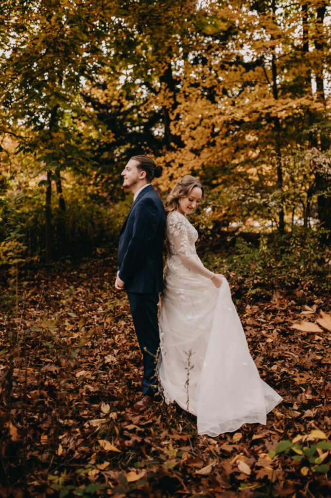 Bride and groom standing back to back and smiling Connecticut Fall Wedding Photography 